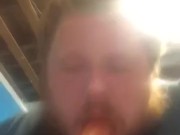 Fat guy sucking on dildo