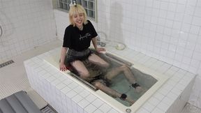 Japenese girl submerges a man into the bathtub with a facesitting