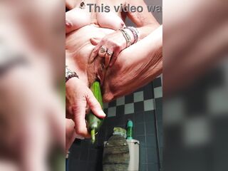 Granny bangs bushy cunt with cucumber