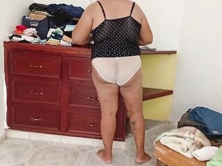 Overweight Mommy Tidying Up Room And Folding Laundry three