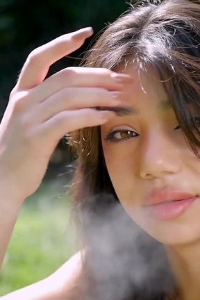 Arina Is Smoking One Black Cigarette Outdoors