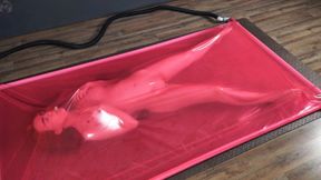 Masturbation in a pink latex vacuum bed