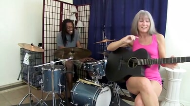 Blonde woman with gray hair takes black musician deep in throat and bed
