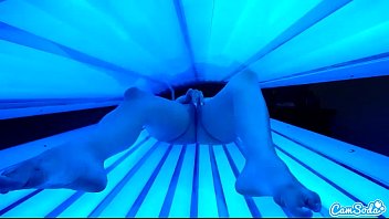 teen latina student gives lesbian pussy a massage in tanning bed