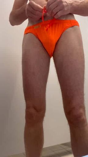 Hairy athletic swimmer with sexy orange swimsuit