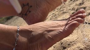 Pretty feet in the sand