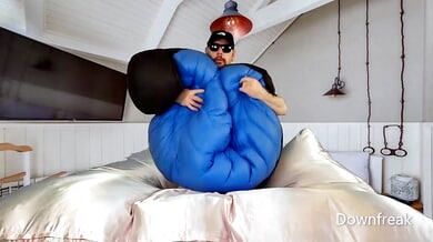 A man in a puffy jacket jerks off and cums hard on camera during a solo fetish session