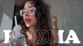 A girl with a split tongue gives herself an enema on camera.