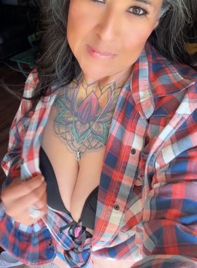 Tattooed woman in plaid shirt