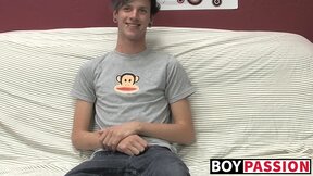 Cute gay guy Danny jerks off his cock on couch solo