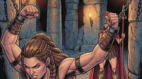 Woman with muscled body and hairy pits in dungeon BDSM bondage struggles to free herself