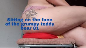 Sitting on the face of the grumpy teddy bear 81