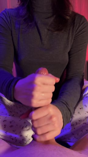 Mature woman in a black turtleneck sitting on a bed