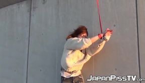 These restrained Asian babes are pissing down their pant legs