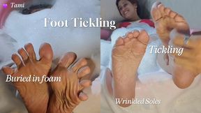 Buried under a lot of foam, she receives tickling on the soles of her feet (4)