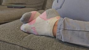 Chrissy laying on couch in puma socks pt3