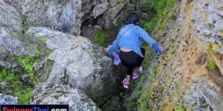 Thai MILF with big tits explores the cave and gets hornier