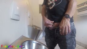 I'm pissing into the urinal of a public restroom and jerking off my thick cock until I'm precumming. I wanted to cum, but...
