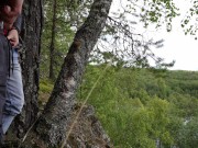 Two tight streams of urine cross in the mountains. Pissing outdoor UHD 4K video