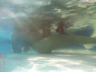 Elegant and supple playgirl, swimming underwater in the outdoor swimming pool. three 1