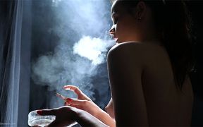 Young Brunette Smoking in Red Tulle Skirt