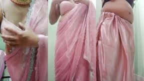 indian gay crossdresser gaurisissy pressing and playing with her big boobs looking in pink saree looking like a housewife