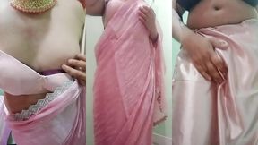 indian gay crossdresser gaurisissy pressing and playing with her big boobs looking in pink saree looking like a housewife