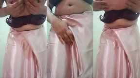 indian gay crossdresser gaurisissy pressing and playing with her big boobs looking in pink saree looking like a housewife