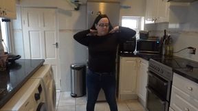 in the kitchen undressing in jeans and black top