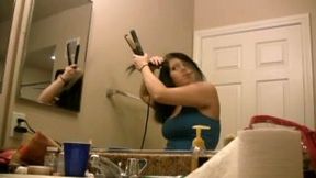 Hot and busty brunette babe in the bathroom brushing her hair