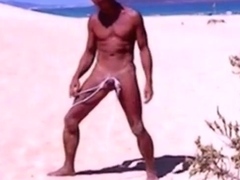 Tanned guy on beach in tiny string thong (temporarily!)