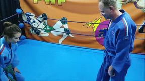 Fem judo fighter in a gi wrestles