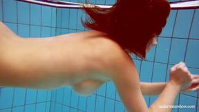 ”Big tits petite babe Deniska swimming in the pool”