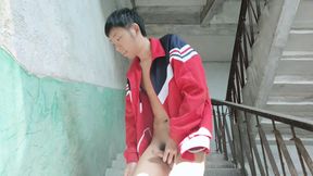 A mischievous Asian boy masturbates and moans as he ejaculates profusely on the sunlit stairs of an abandoned factory, then inge