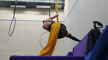 Practicing hip locks on the aerial silks