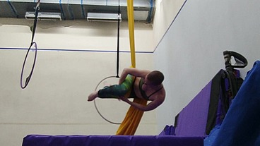 Practicing hip locks on the aerial silks
