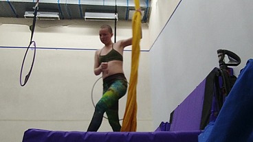 Practicing hip locks on the aerial silks