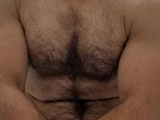 Muscle bear flexing in red boxer breifs