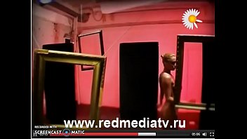 Svetlana Demeschenko looking through a picture frame and stripping