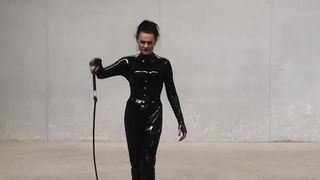 The Queen Obsidian possesses her singletails ominously in her spandex catsuit.