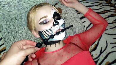 Blonde in red sheer top and skull face paint trains her ass with long anal beads