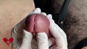 Glans game with white latex gloves in super-closeup. Alternative view.