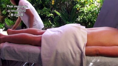 Outdoor Thai massage turns intimate under the trees