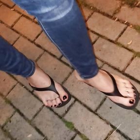 a crossdresser with beautiful feet walks the street and seduces in sexy flip-flops