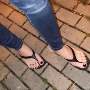 a crossdresser with beautiful feet walks the street and seduces in sexy flip-flops