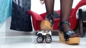 crushing different toy car in sexy heels and sandals