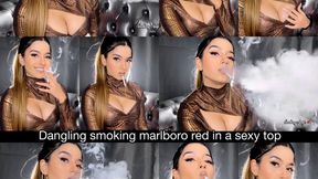 Dangling smoking marlboro red in a sexy low cut top, ponytail, hoops and nude glossy lips!