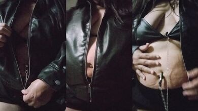 Goth girl in leather belly dancing on her joyful navel