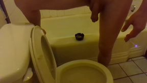 Pissing in the Toilet While Standing on the Bathtub