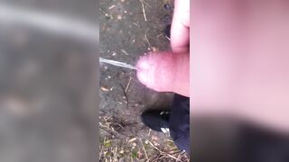 chav peeing and wanking into a field